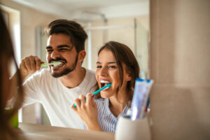 Couple brushing teeth together Orthodontics Portage